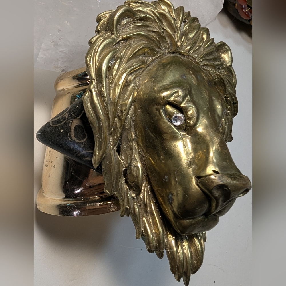 Wendy Gell massive lion head with jeweled eyes and Picasso Stone on a gold cuff.